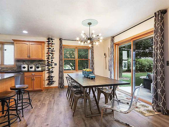 Kitchen opens to window flanked dining area.