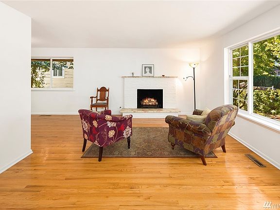 Spacious Living Room has gas fireplace and hardwoods and opens to Dining and Kitchen areas.