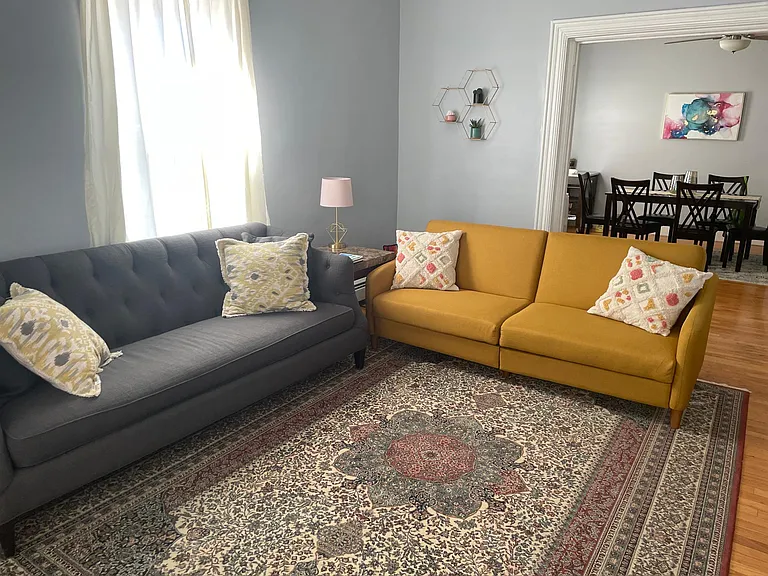 Large living room with 10+ ft ceilings and excellent natural light
