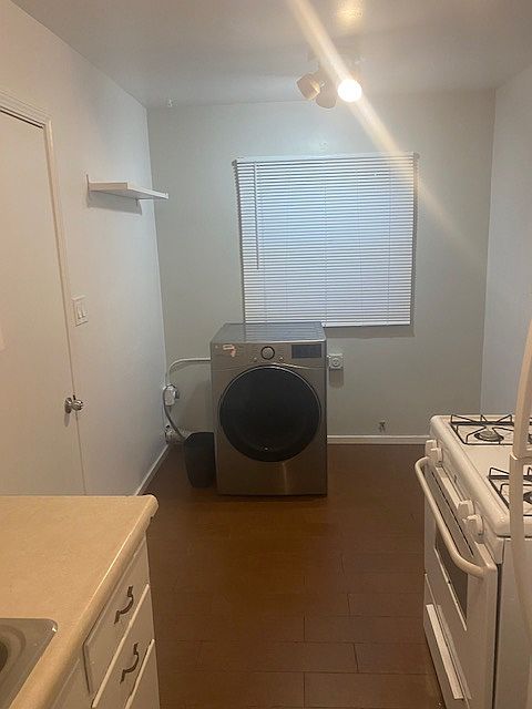 Kitchen photo showing dryer and area for dinette