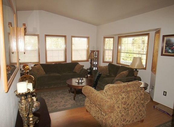 Open Living Room crowned with Vaulted Ceiling