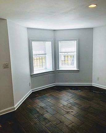 Bright, street-level windows in living room