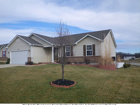 From Southwest corner showing front lawn, landscaping & vinyl fenced back yard