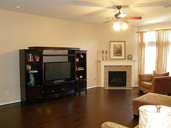 Gas log fireplace and laminate flooring throughout the house.