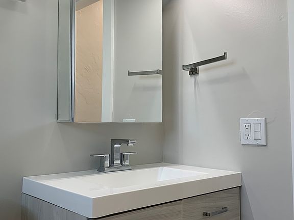 A modernist's dream bath come true! storage in both vanity and medicine cabinet.