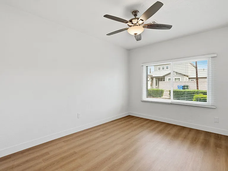 Bedroom 1 has large east facing window. Large room with ceiling fan.