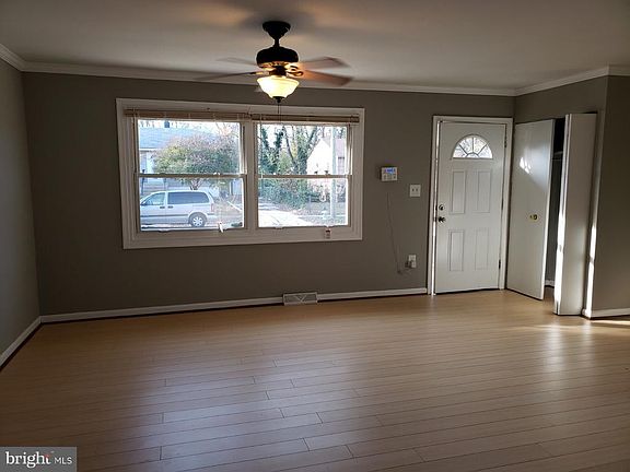 Spacious well lit living room with new floors.