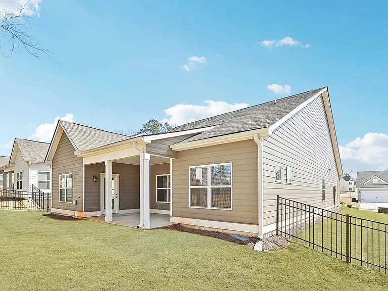 Covered back patio with fenced in yard.