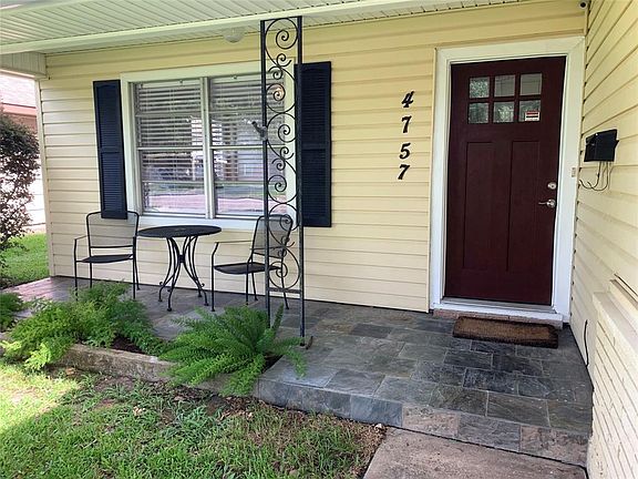 Inviting front porch with slate tile. Craftsman style front door replaced.