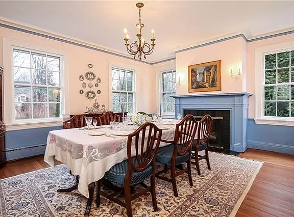 The formal dining room is a perfect setting to entertain friends, particularly in the cold weather before a roaring fire in a se