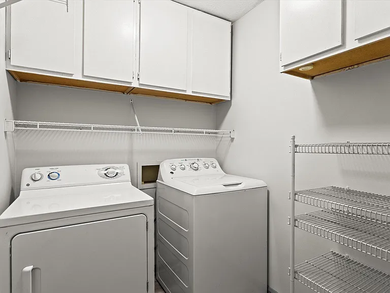 Upstairs laundry room equipped with washer and dryer.
