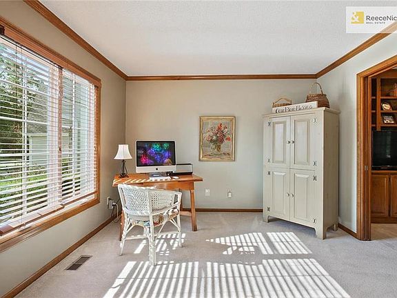 The Formal Living Room or Office is on the front of the home and boasts beautiful windows and custom blinds.