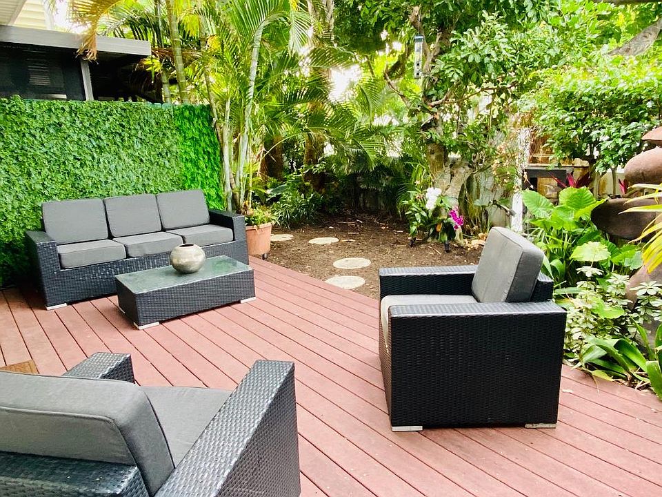 Private tropical oasis. Corner unit with private backyard deck , lush landscaping, lighting, water features.