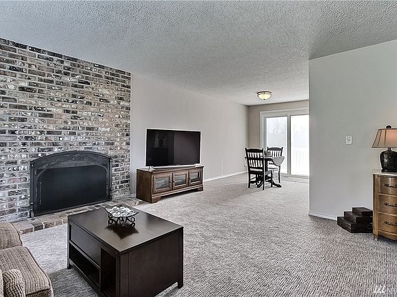 Living room view to dining with patio doors leading to your deck.
