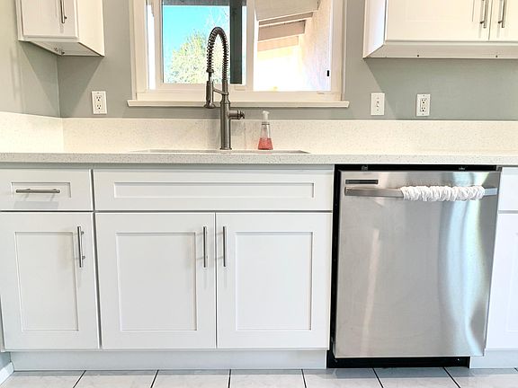 New cabinets, countertops, sink, and dishwasher.