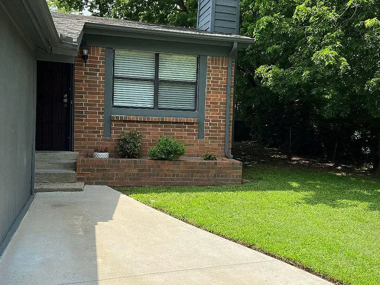 Front yard sidewalk exit/entry to garage side door or wrought iron gate.