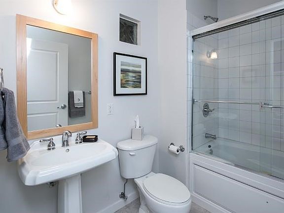 Main bathroom off entryway is complete with shower and tub.