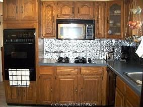 Large eat-in kitchen with built in microwave and new backsplash