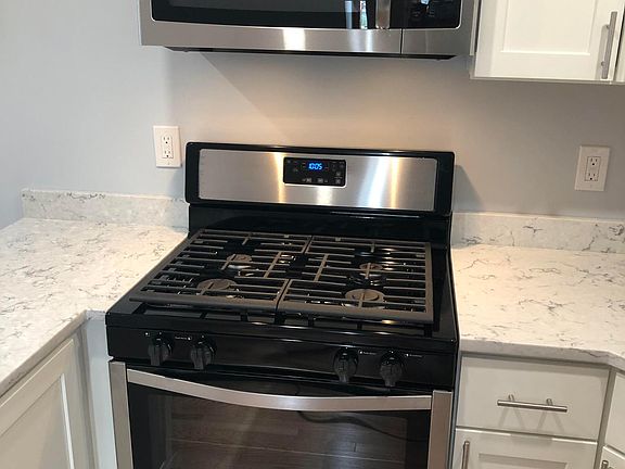 New 5 burner gas stove and new over the range microwave oven overhead.