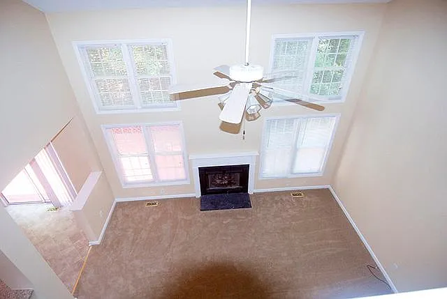 Living room with beautiful bright windows and views. Gas log fireplace
