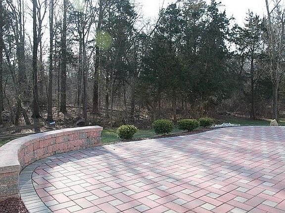 Brick patio w/ sitting wall and new landscaping - backing to green acres
