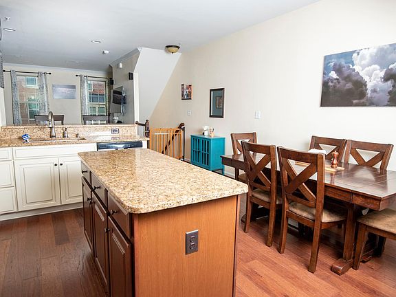 Open concept kitchen with island, breakfast bar, and granite countertops
