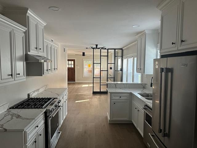 View of Kitchen, dining room and living room while standing an entry of pantry.