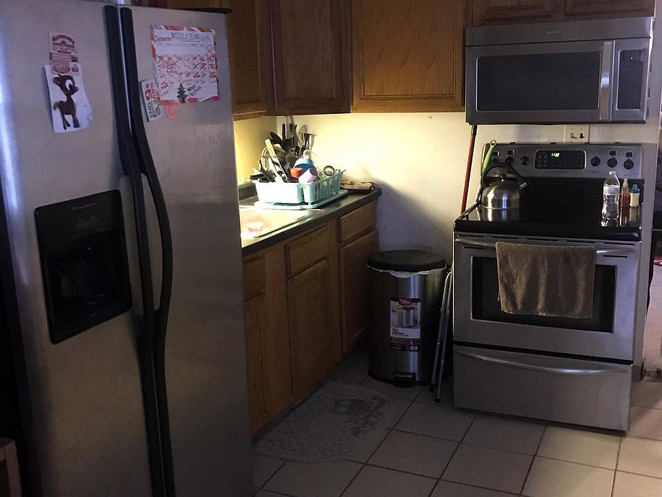 Stainless steel fridge stove and over the range microwave track lighting ceramic flooring recently remodeled