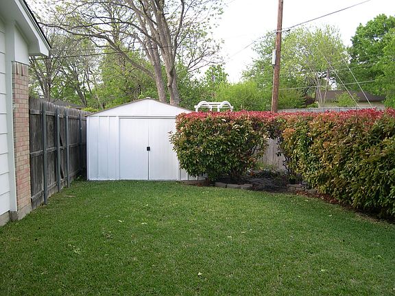 Backyard includes large shed and organic children's secret garden