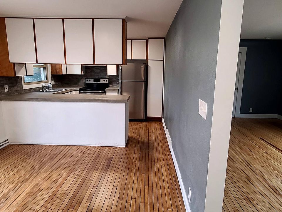 Kitchen and dining area (private deck access) on left side and Living room on right side.