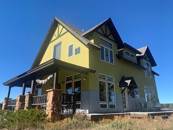 East side of home with access from the kitchen to the east deck. Great eastern mountain views from this side.
