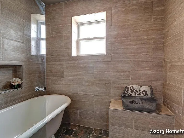 Master floor bathroom with sitting tub and rainfall shower