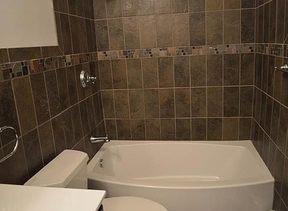 Completely renovated bathroom with top of the line fixtures & tiles from Best Plumbing.