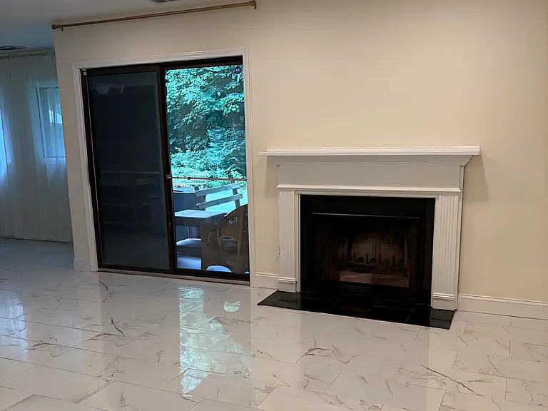 Living Room with Fireplace and Patio View