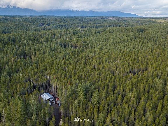 Aerial view capturing the peacefulness of your beautiful, wooded property. 
