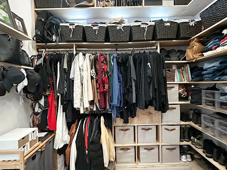 Large primary walk in closet with custom built-ins.