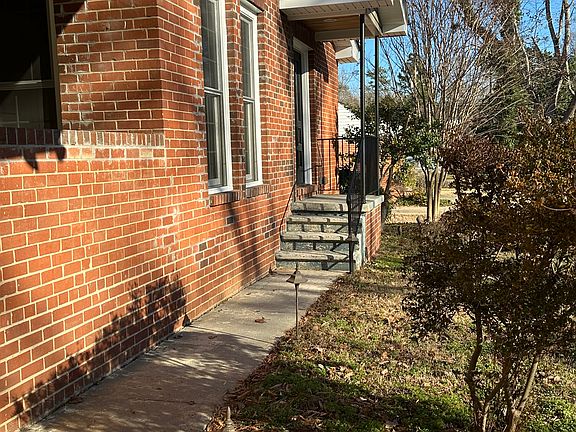 Walkway with landscape lighting to front porch