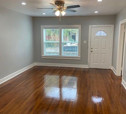 Living Room with recessed Can Lighting and ceiling fan.