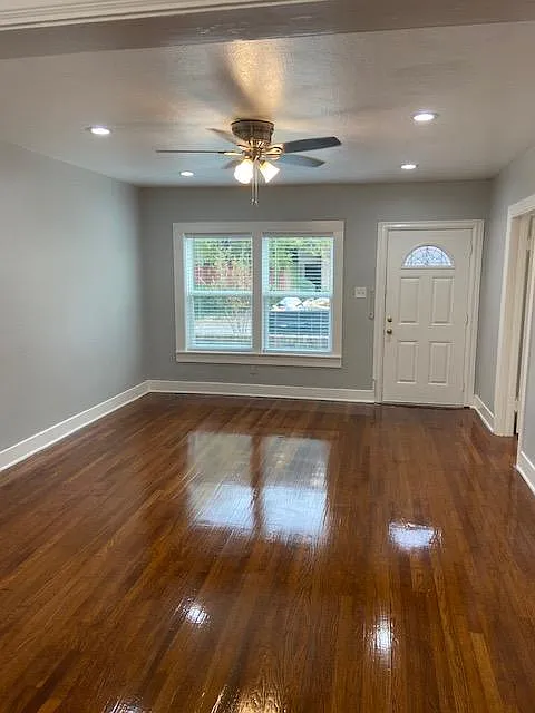 Living Room with recessed Can Lighting and ceiling fan.