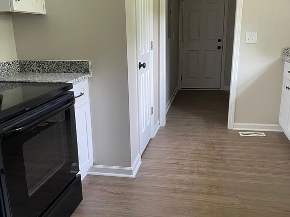 kitchen with pantry and leading to laundry room and garage eat