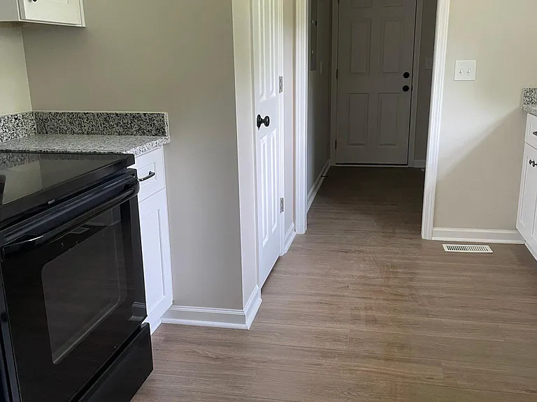 kitchen with pantry and leading to laundry room and garage eat
