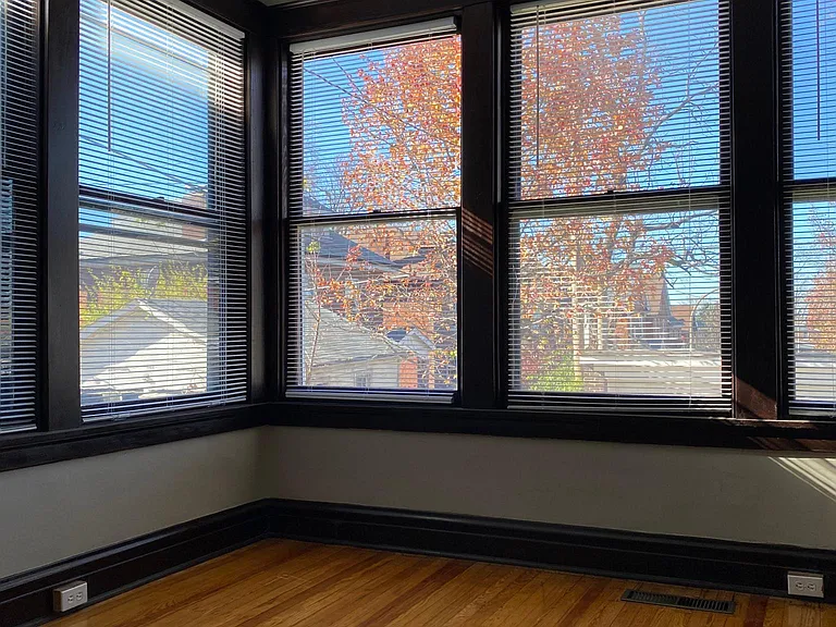 Spacious sunroom with plenty of outlets, new pendant lighting, and HVAC vent.