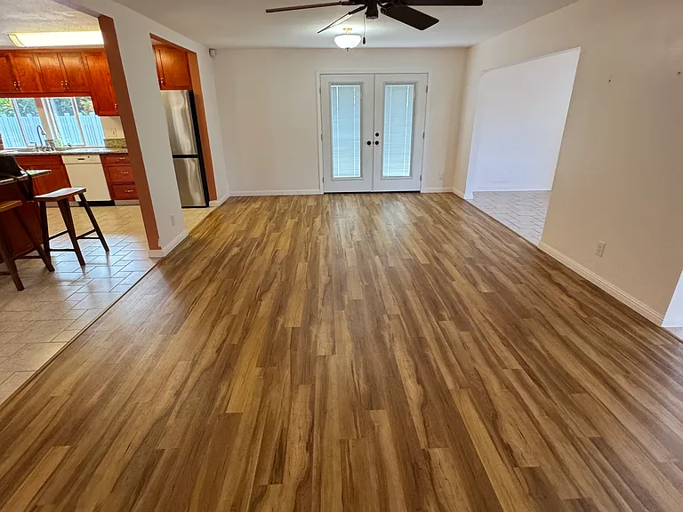 View of the great living room area. With an door leading to the lounging area/sidewalk to bonus room