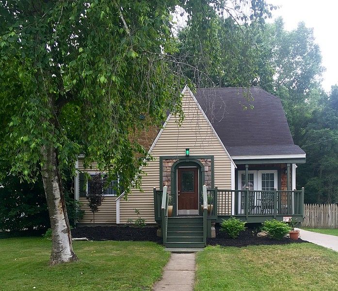 Tudor Style home with bistro seating : Street view of home. French doors from dining room that lead 