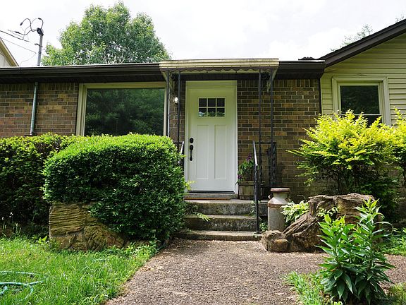 Ranch house with fenced in front and back yard.