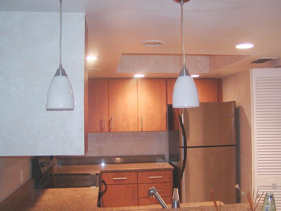 Kitchen-stainless steel appliances and wood cabinets, breakf