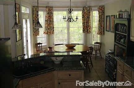 Kitchen opens to eating area : Overlooking wooded backyard and open to back deck with bar that seats