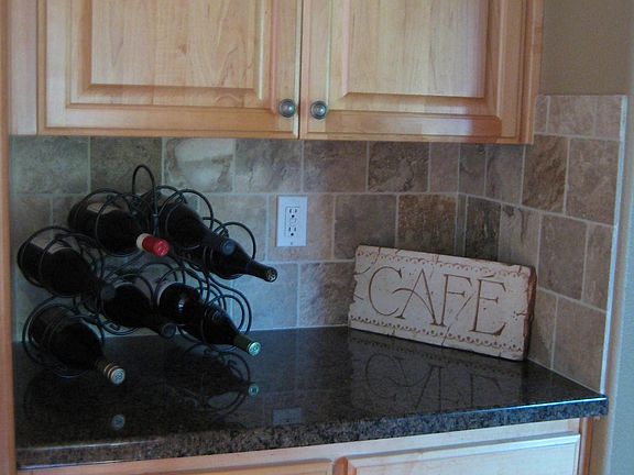 Slab Granite and Cabinet high Travertine backsplash