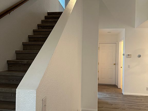 Stairs up to bedrooms and open area overlooking front entry area.