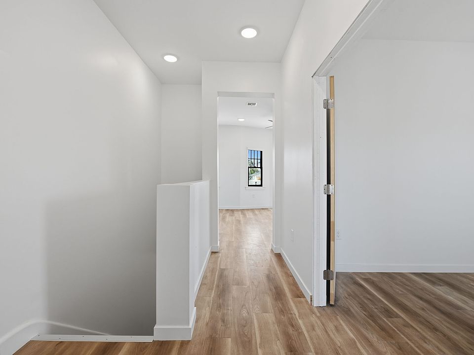 Entry from patio and looking towards the living room. Guest bedroom on the right.